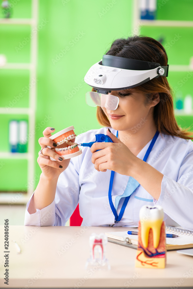 Woman dentist working on teeth implant Woman dentist working on teeth implant