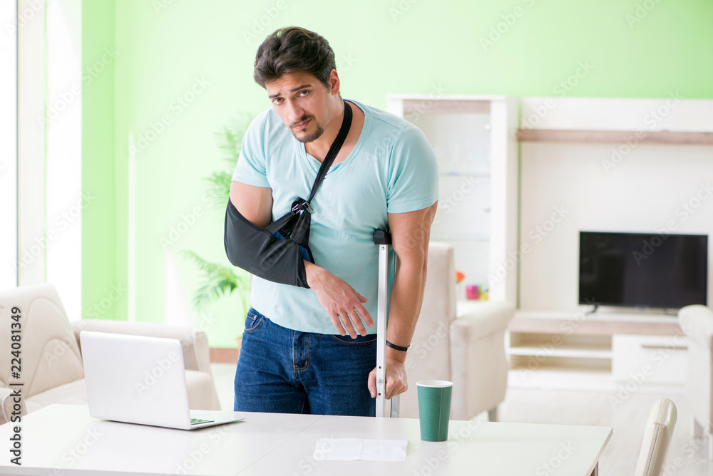 Injured man with crutches sitting at home 