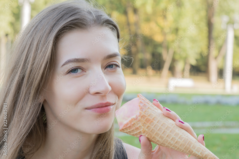 portrait of a caucasian woman with ice cream in park portrait of a caucasian woman with ice cream in park