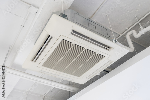 Cassette type air condition with lighting and fire protection system installation on ceiling.