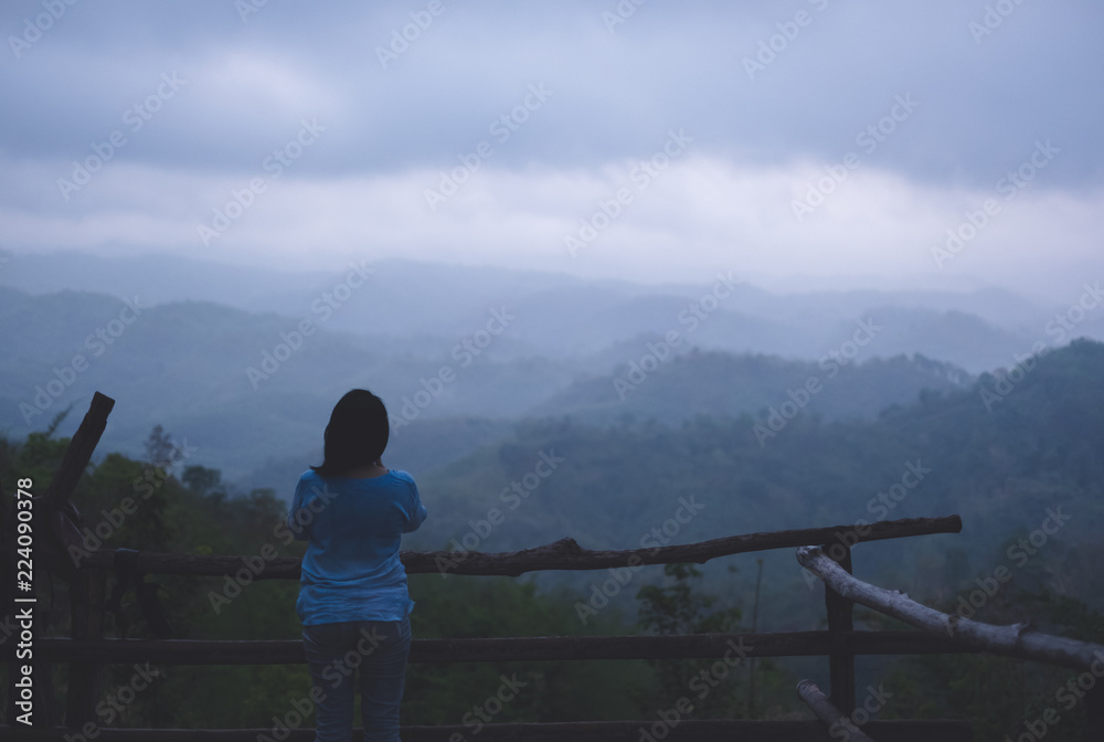 Asian traveler woman at mountain natural view point with fog in morning.freedom lifestyle travel concept.