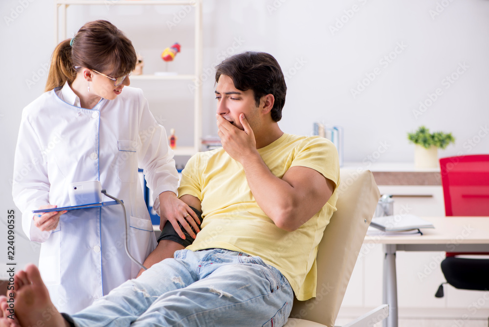 Young doctor checking patients blood pressure Young doctor checking patients blood pressure