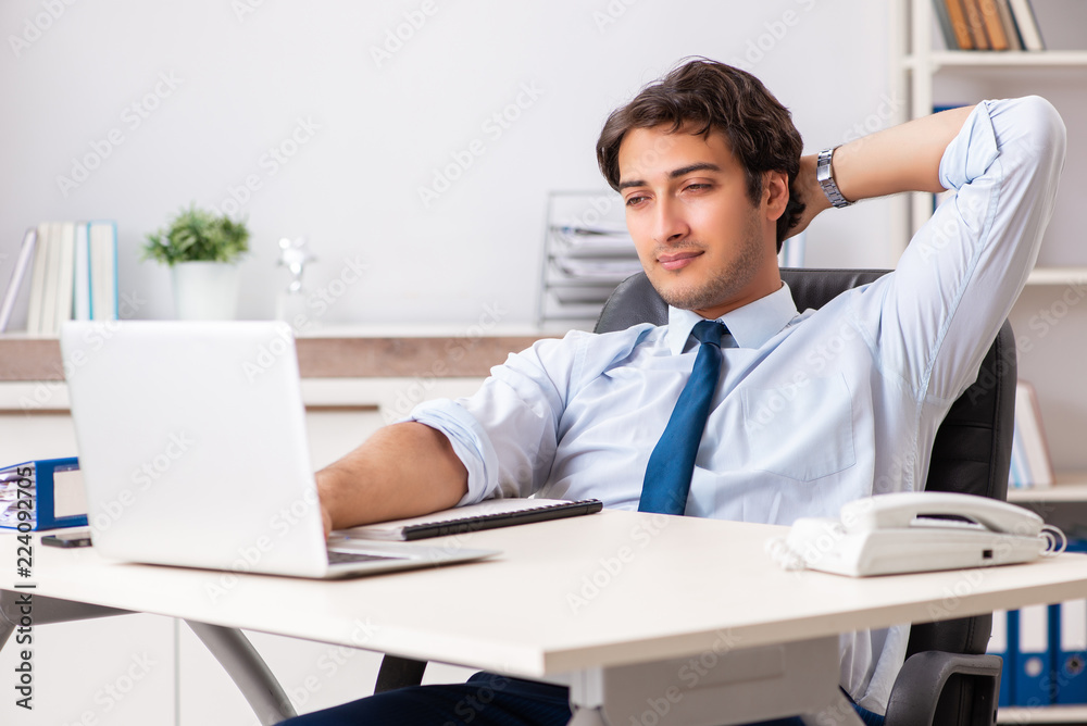 Young handsome businessman working in office