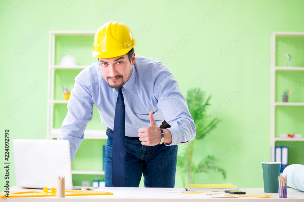 Young male architect working at the project Young male architect working at the project