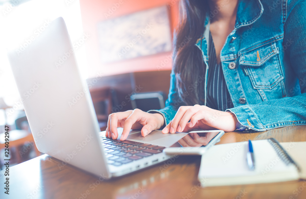 Women hand are using a computer laptop in the office.