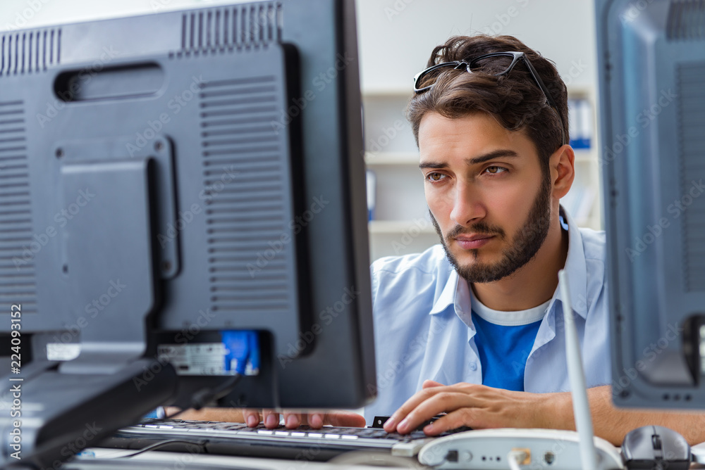 IT technician looking at IT equipment IT technician looking at IT equipment