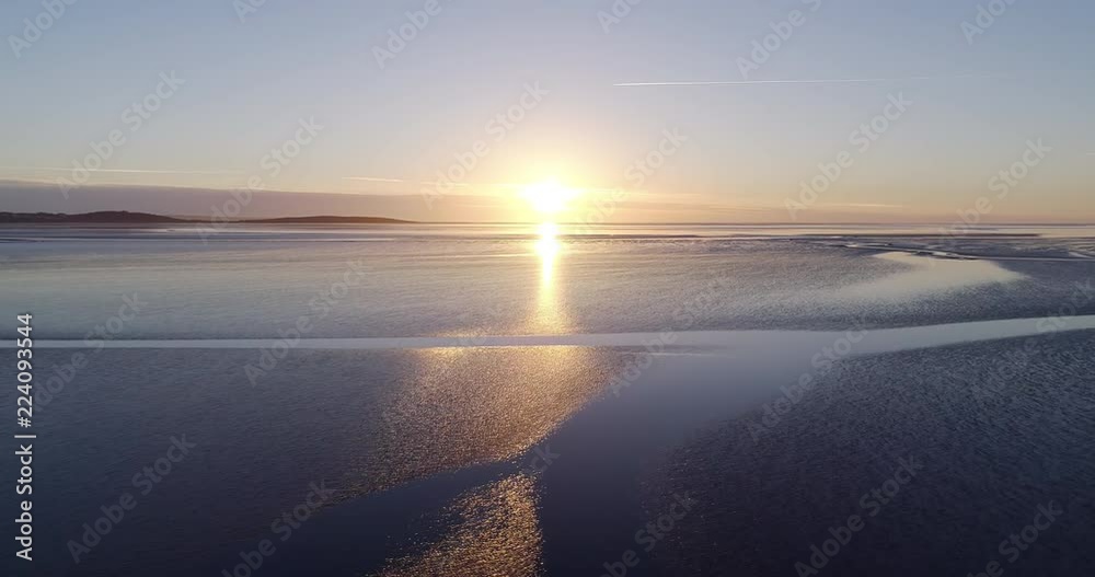 Aerial shot of sunset over the sea at low tide. Aerial shot of sunset over the sea at low tide.