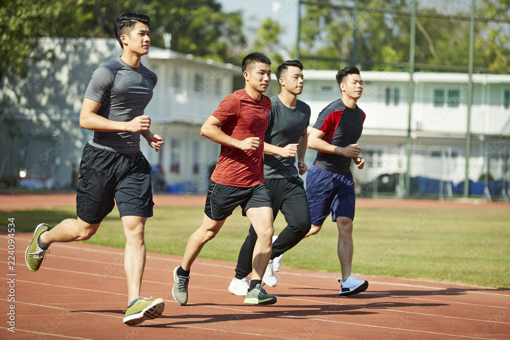 young asian athletes running on track