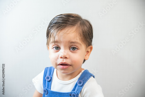 Cute baby boy toddler - with blue romper on white background