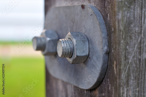 screw-nut fixing metal plate at wooden girder