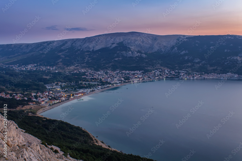 Village Baska at sunrise with sea and hills, island Krk, Croatia