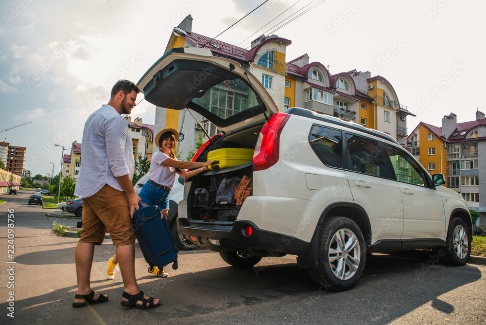 car travel concept. opened trunk with luggage inside woman with car travel concept. opened trunk with luggage inside woman with