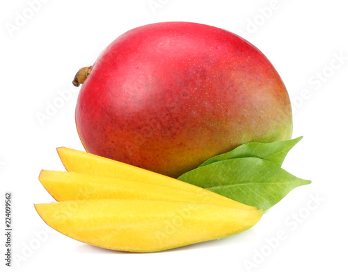 mango with slices and green leaves isolated on white background. healthy food.