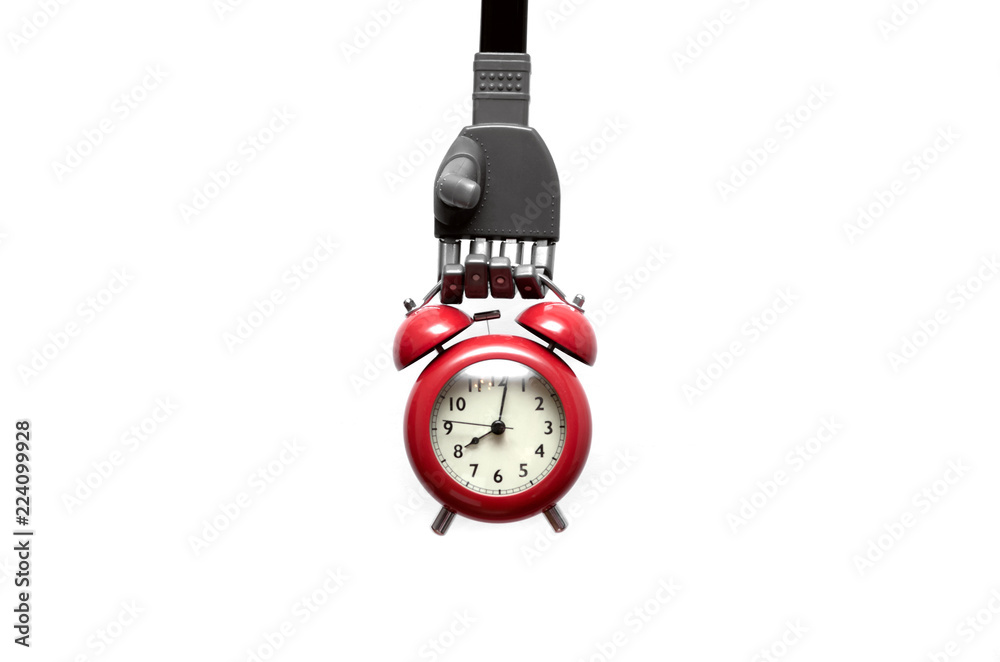 Toy robot hand is holding a red alkarm clock isolated on white background. Digital reminder. Toy robot hand is holding a red alkarm clock isolated on white background. Digital reminder.