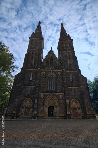 Ancient Neo Gothic Church of Saint Peter and Paul in Vysehrad ("Upper Castle"). Summer landscape photo on a sunny morning. Selective focus with wide angle view. Prague, Czech Republic