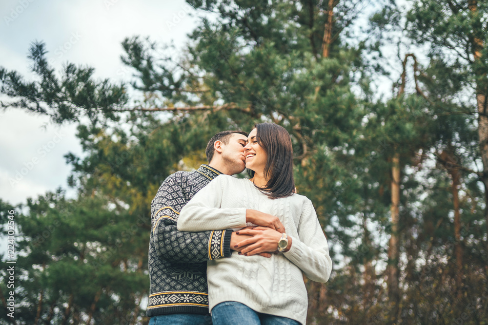 Fototapeta premium Pretty young couple walking together in the forest.