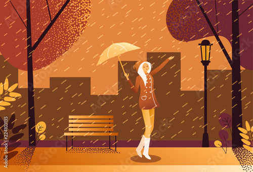 Girl with umbrella walks in the rain in park.