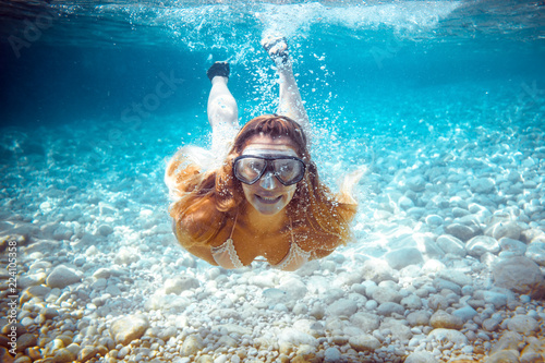 Girl snorkeling underwater in the tropical sea