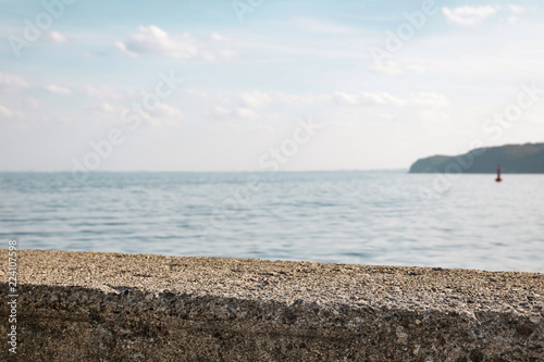 Fototapeta Naklejka Na Ścianę i Meble -  stone wall by the sea with an empty place for an advertising product   