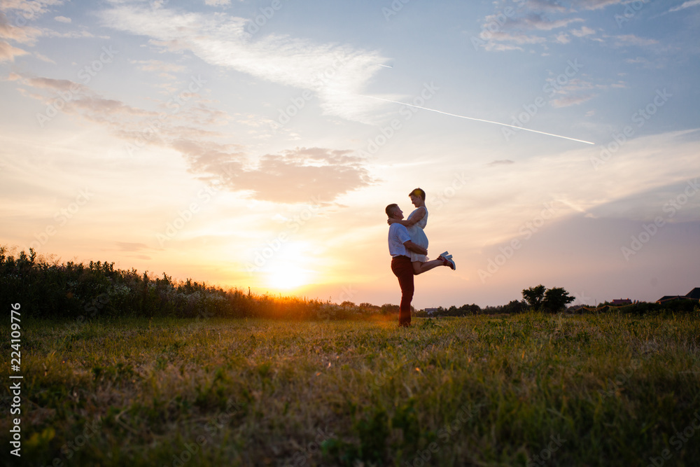 Rustic wedding couple at sunset in the summer outdoors