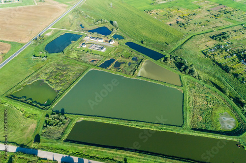 Aerial view of ity station for wastewater treatment. A lot of ponds with dirty and cleaned water.