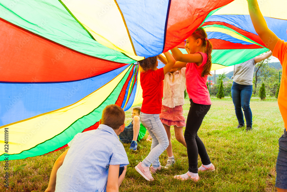 Fotografi Group of kids trying to fix up fallen canopy