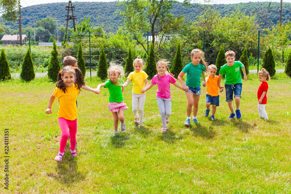 Obraz premium Runnig children at summer camp in the summer outdoors