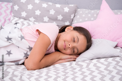 Girl child fall asleep on pillow. Quality of sleep depends on many factors. Choose proper pillow to sleep well. Girl lay on pillow bedclothes background. Child having nap. Cute badclothes and pillows