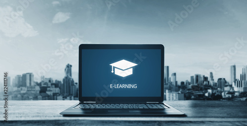 E-learning on computer laptop and city background. Online education, e-learning and e-book concept