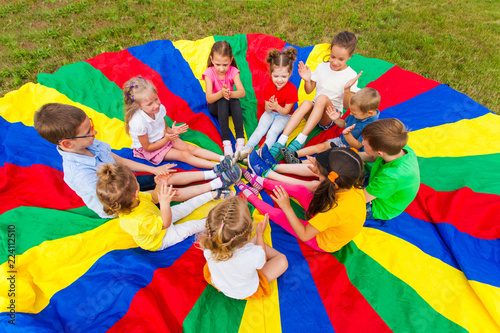 Kids clap the hands in the summer outdoors photo