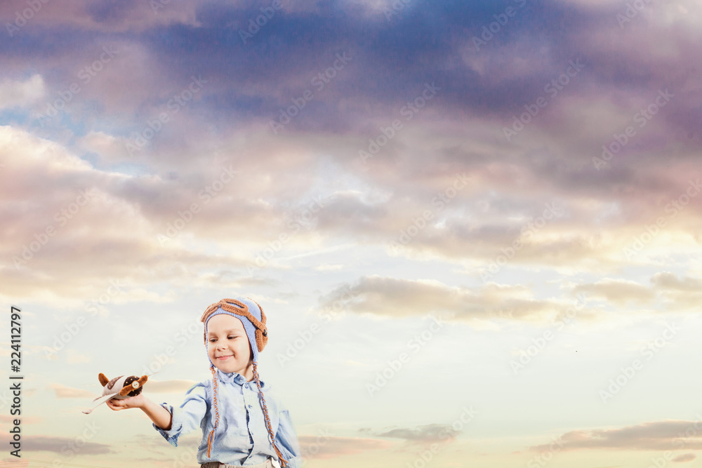 Little boy pilot in the sunset sky Little boy pilot in the sunset sky