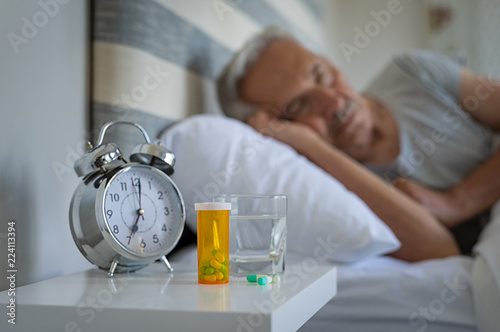 Obraz na plátně Man sleeping with medicines