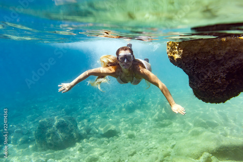 Young woman snorkeling and diving in tropical sea
