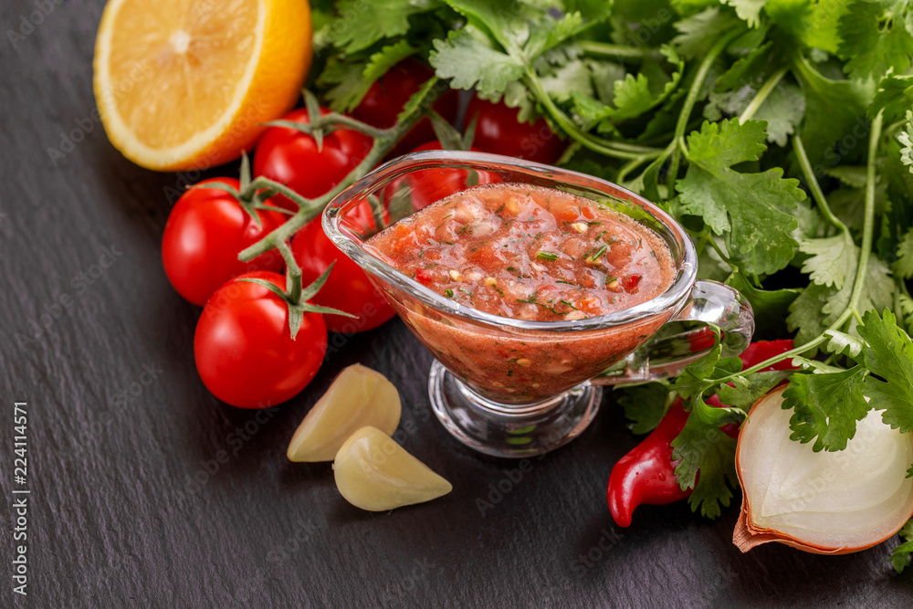 Traditional mexican red spicy sauce salsa with ingredients Traditional mexican red spicy sauce salsa with ingredients