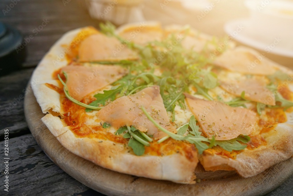 Pizza salmon on the table with warm light Pizza salmon on the table with warm light