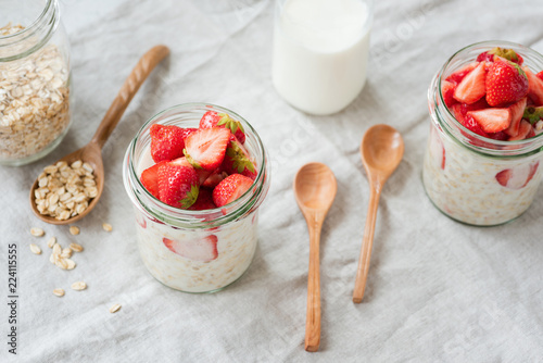 Obraz na płótnie Overnight oats with strawberries and almond milk in a jar