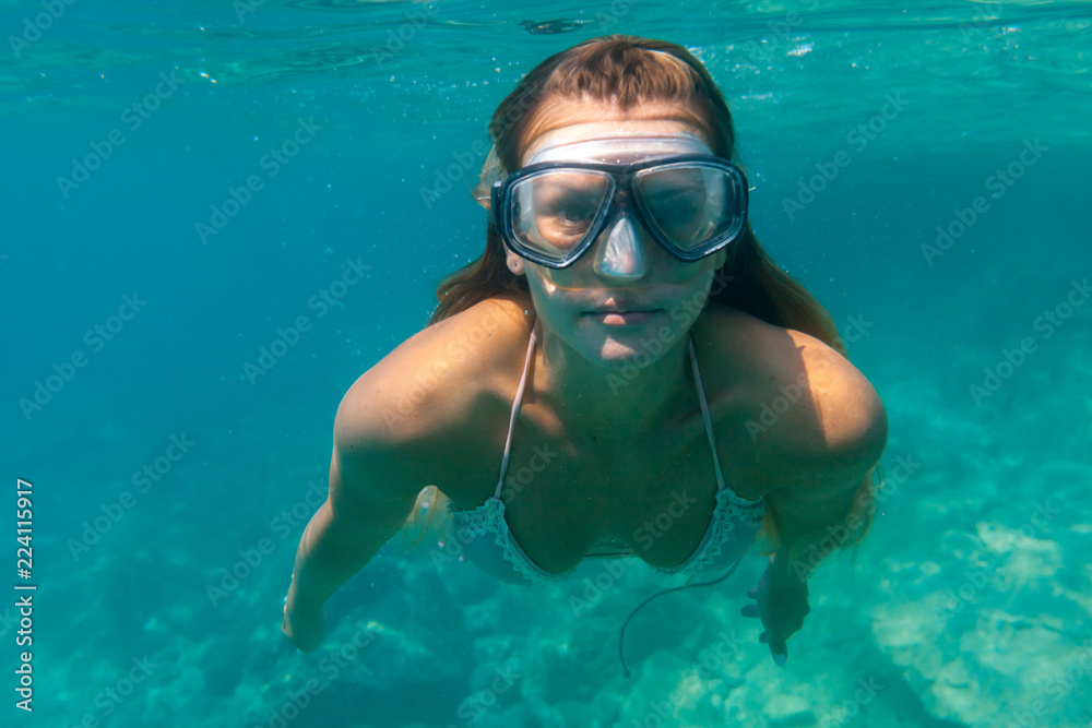 Young woman snorkeling underwater in the tropical sea
