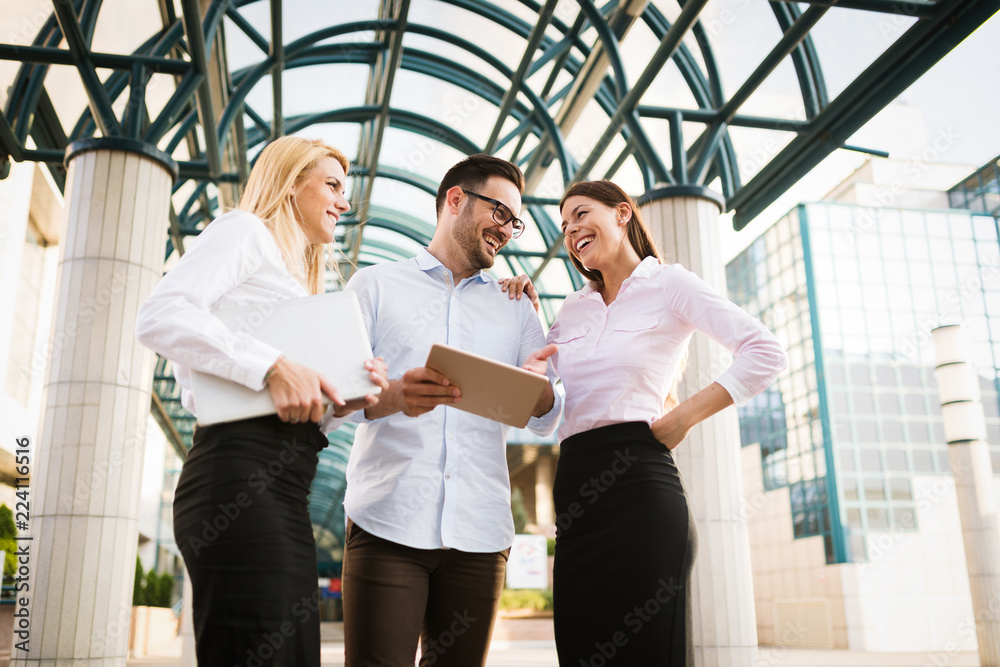 Picture of young attractive business partners standing Picture of young attractive business partners standing