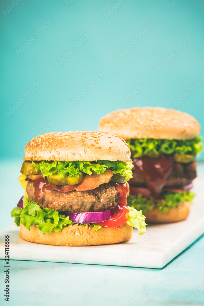 Homemade hamburgers on blue background