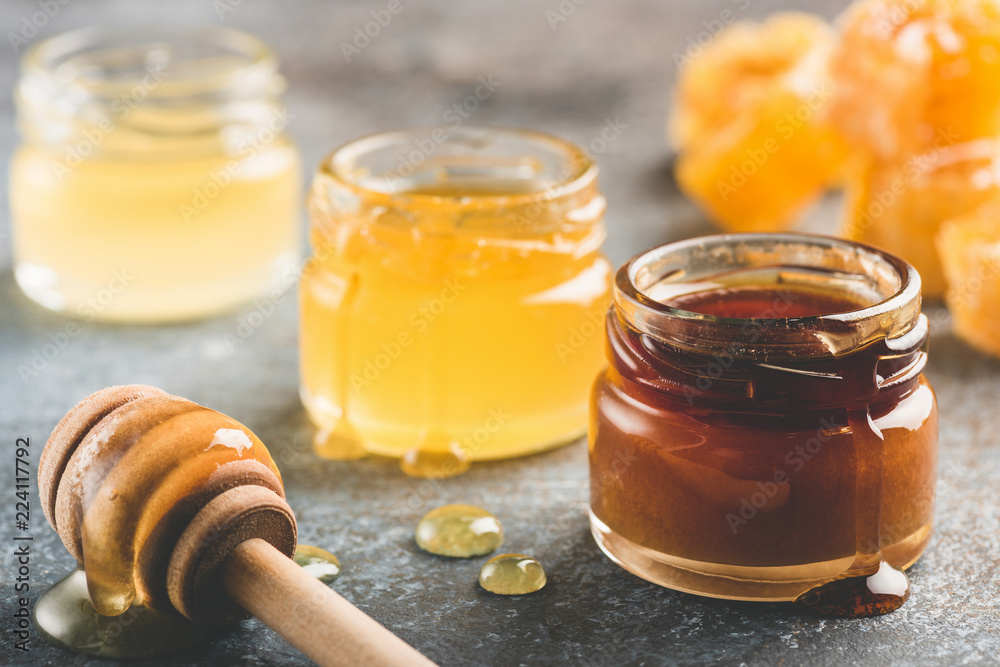 Selection of honey in small honey jars. Closeup view, toned image