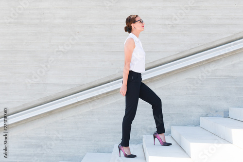 business woman climbs the stairs