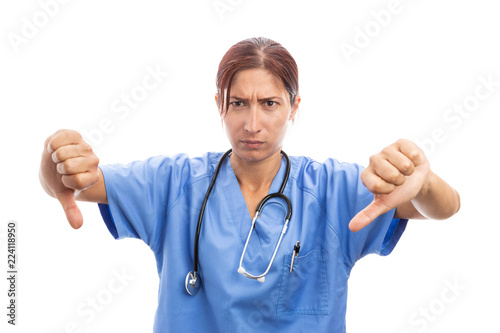 Angry unhappy woman nurse or doctor making thumbs down gesture.