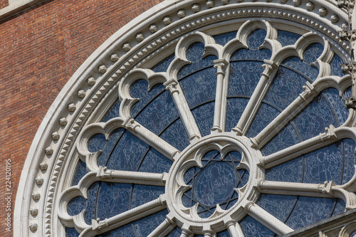 rosette or circular window filled with stained glass and ornamentation in the facade of neogothic Church of the Sacred Heart of Jesus, Graz,Austria