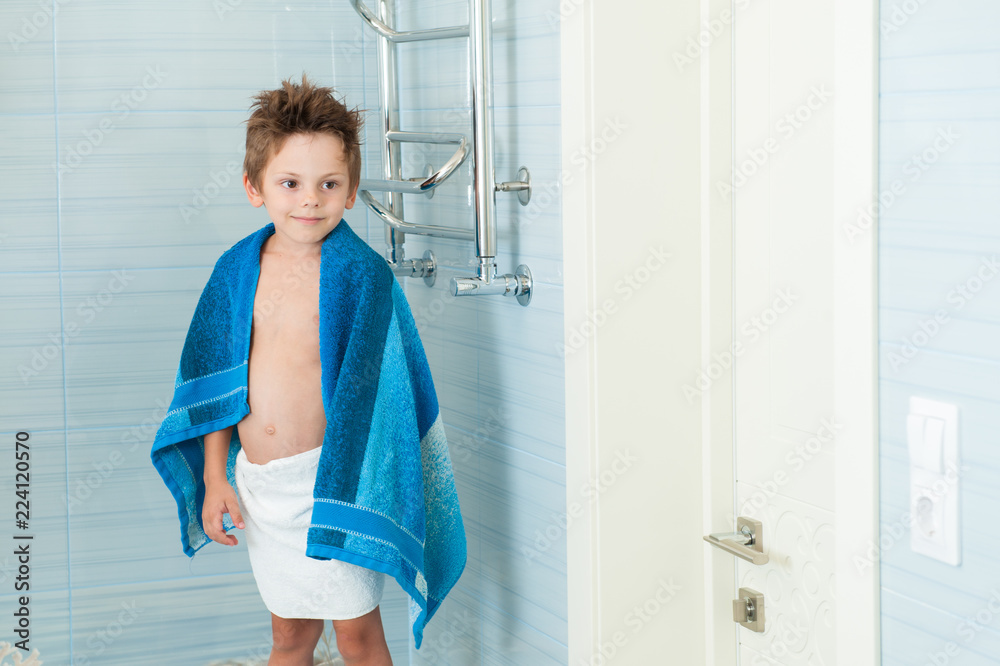 cute healthy little caucasian boy with blue towel in bright bathroom cute healthy little caucasian boy with blue towel in bright bathroom