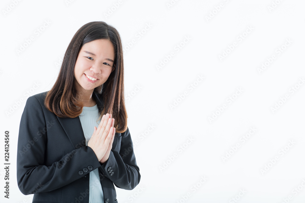 Young and beautiful long balck hair Asian woman in black suit with smile face showing greeting in Thai traditional native style, Sawasdee. Isolated on white background. Young and beautiful long balck hair Asian woman in black suit with smile face showing greeting in Thai traditional native style, Sawasdee. Isolated on white background.