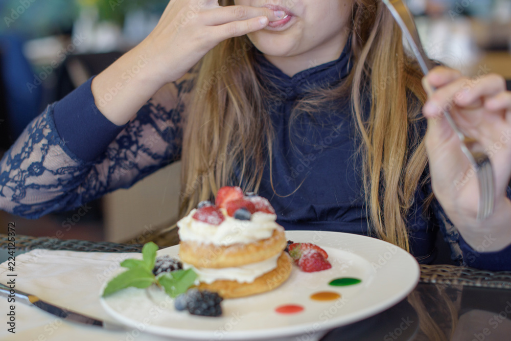 teenage girl eating dessert in a cafe. selective focus teenage girl eating dessert in a cafe. selective focus
