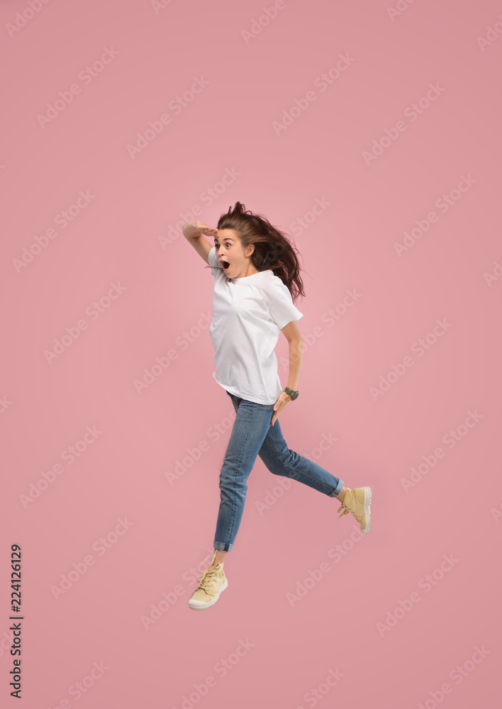What is there interesting in the distance. seeking pretty happy young woman jumping and gesturing against pink studio background. Runnin girl in motion or movement. Human emotions and facial What is there interesting in the distance. seeking pretty happy young woman jumping and gesturing against pink studio background. Runnin girl in motion or movement. Human emotions and facial