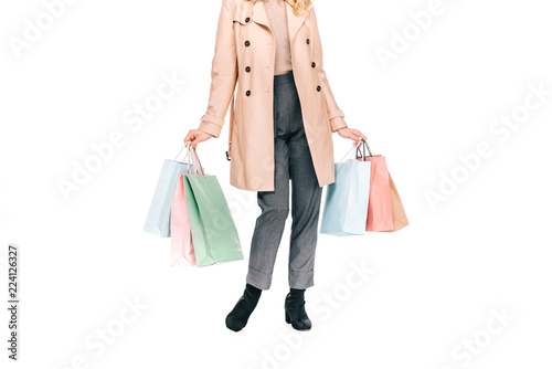 cropped shot of young woman holding paper bags isolated on white