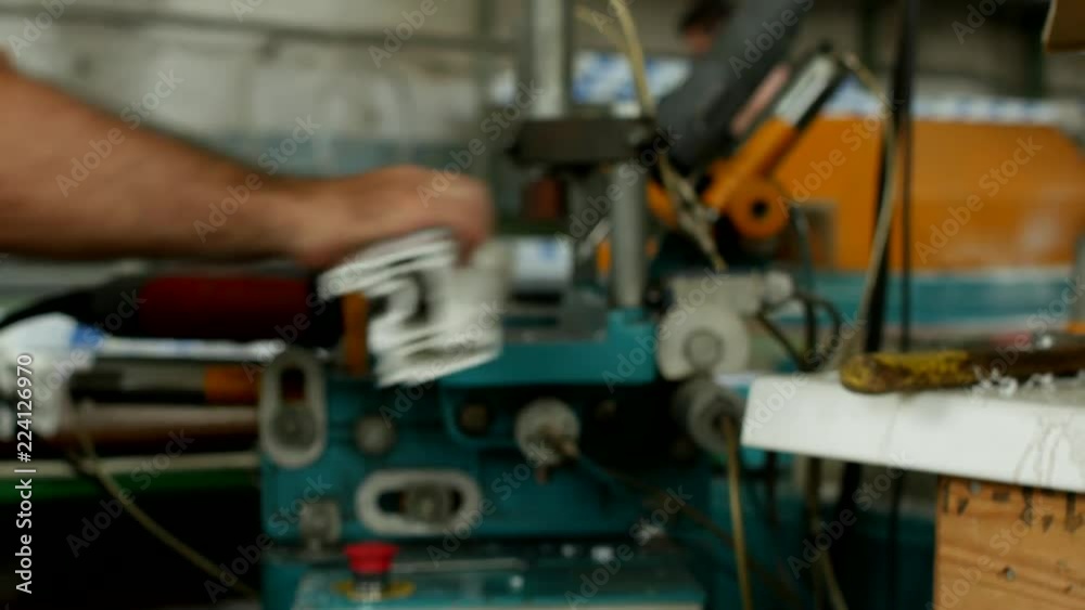 Production and manufacturing of pvc windows, male worker drills holes on a drilling machine in a pvc profile for manufacturing a pvc window, close-up, bench drill Production and manufacturing of pvc windows, male worker drills holes on a drilling machine in a pvc profile for manufacturing a pvc window, close-up, bench drill