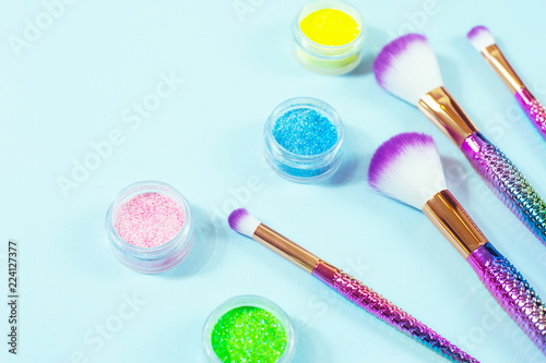 Set of mermaid tail make-up brushes. Make up tools on pastel backg